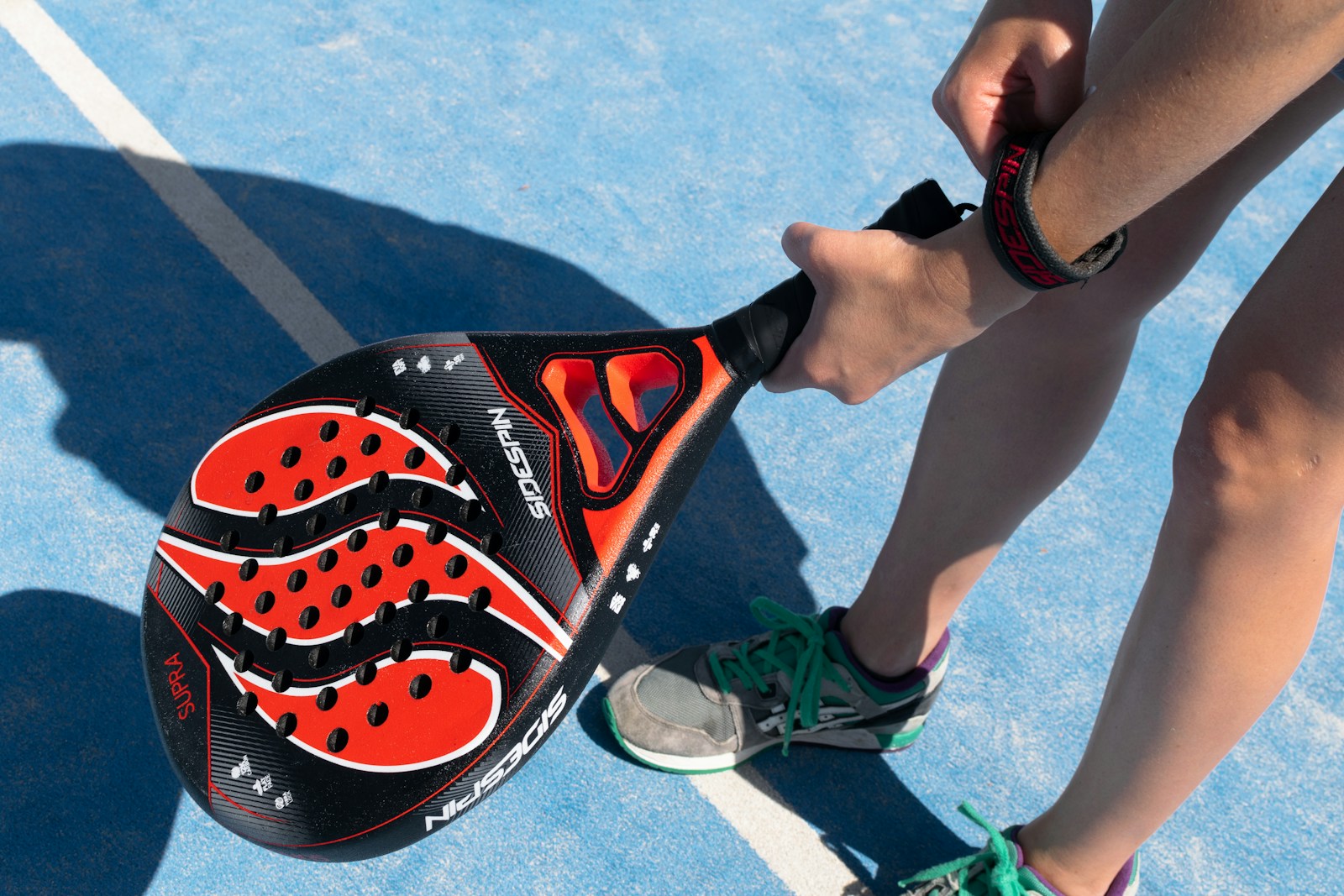 a close up of a person holding a tennis racket