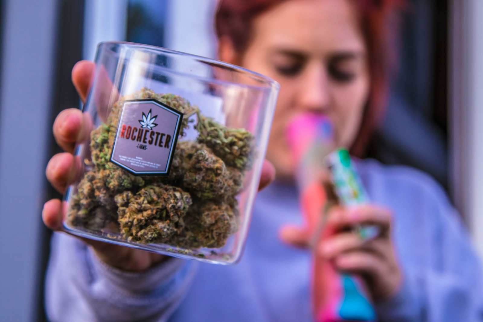 woman holding Rochester kush container